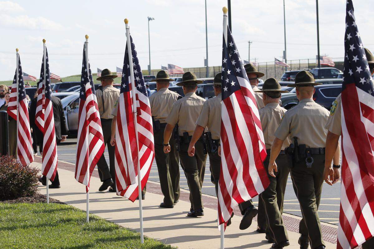 Illinois State Police troopers arrive for the visitation Saturday or fallen trooper Nicholas Hopkins in Waterloo.
