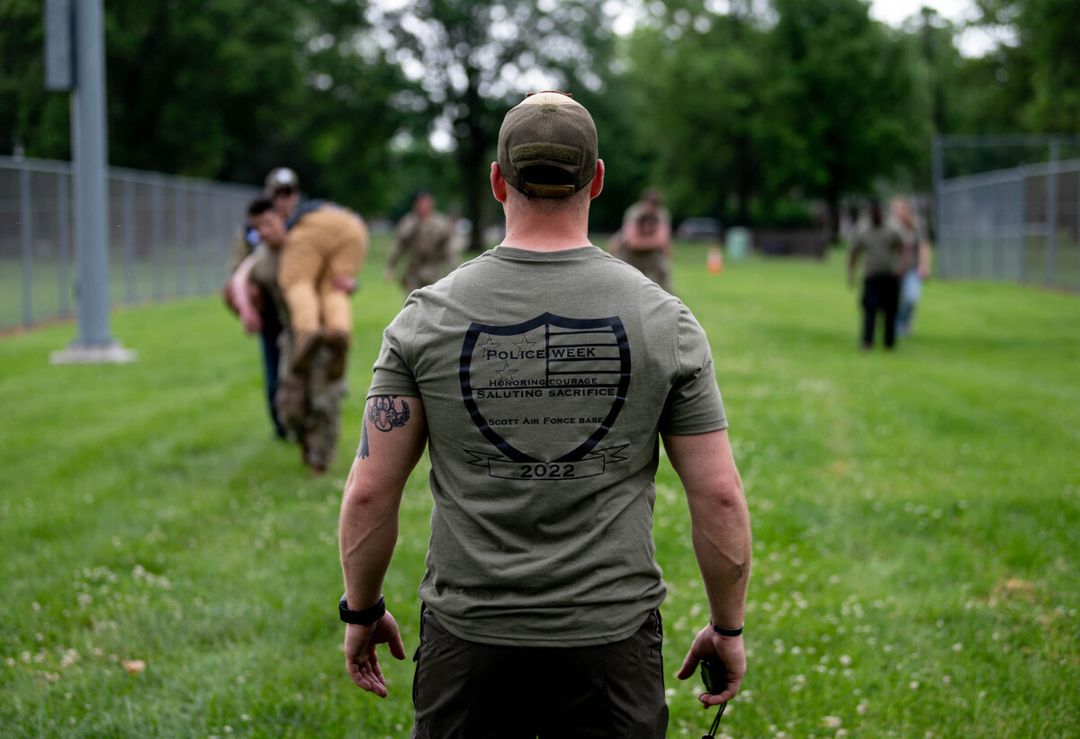 U.S. Air Force Tech. Sgt. Carmen Pontello, 375th Security Forces Squadron kennel master stands at the finish line of an obstacle course in Warrior Park on Scott Air Force Base. Members from the 375th SFS competed against other members from Team Scott as well as other first responders from Fairview Heights and the surrounding community during National Police Week, a week designated by President John F. Kennedy in 1962 to honor and commemorate the service of law enforcement officers that paid the ultimate sacrifice within the line of duty.