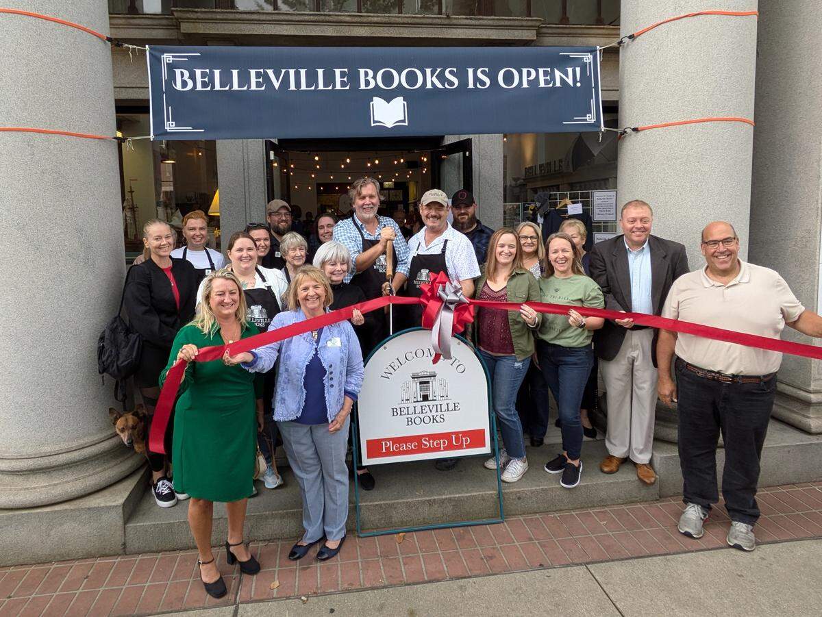 Belleville Books ribbon cutting. At center: owners Steve Mathews (holding scissors) and Rob Eckman