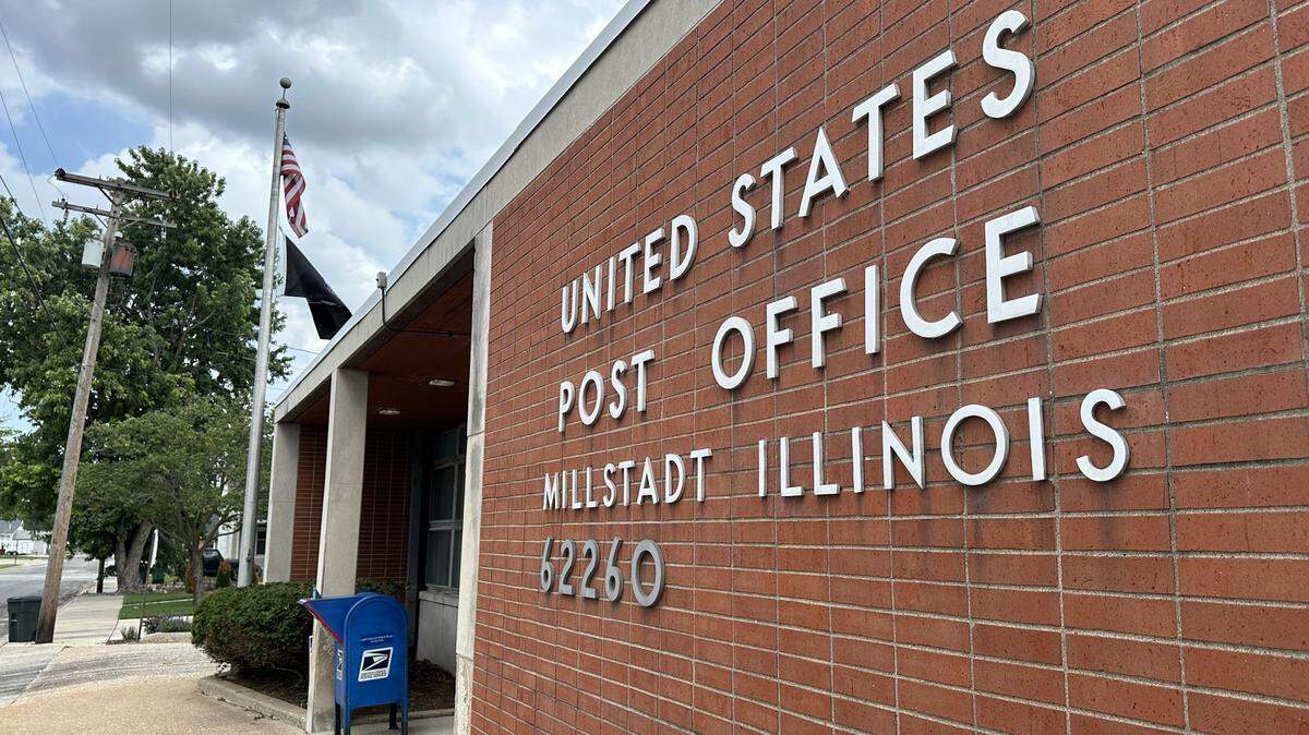 A breeze moves the flags and breaks the heat outside of the Millstadt Post Office on July 30, 2024. Rep. Mike Bost, R-Murphysboro, introduced a bill that would rename the post office after Cpl. Matthew Wyatt, who died in Iraq in December 2004.