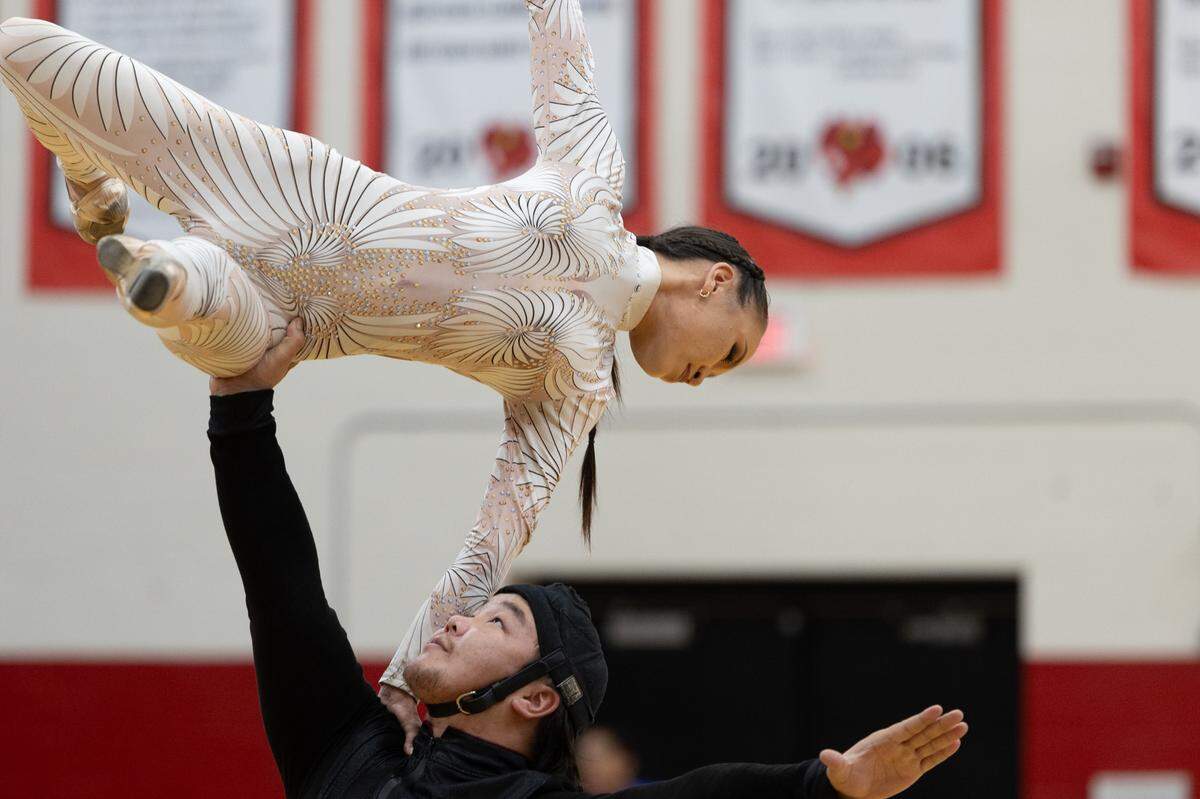 Mongolian performers from the Power of Love act of the UniverSoul Circus perform lifts and spins in front of Mason-Clark Middle School on Aug. 14, 2024.