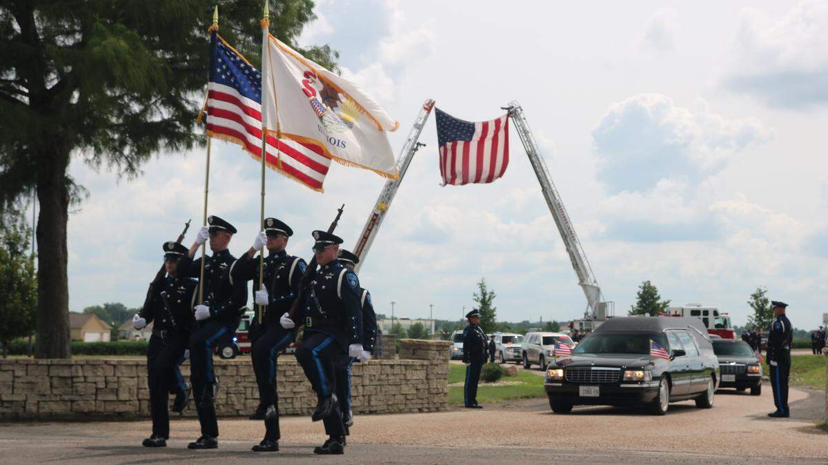 The Collinsville Police Department Honor Guard leads the funeral procession of Highland Police Chief Terry Bell on Aug. 18 at Highland Cemetery.