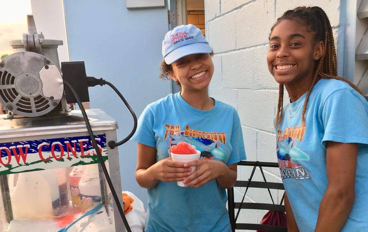 Employees Trenidy Edwards and Charlene Coates on snowcone duty.