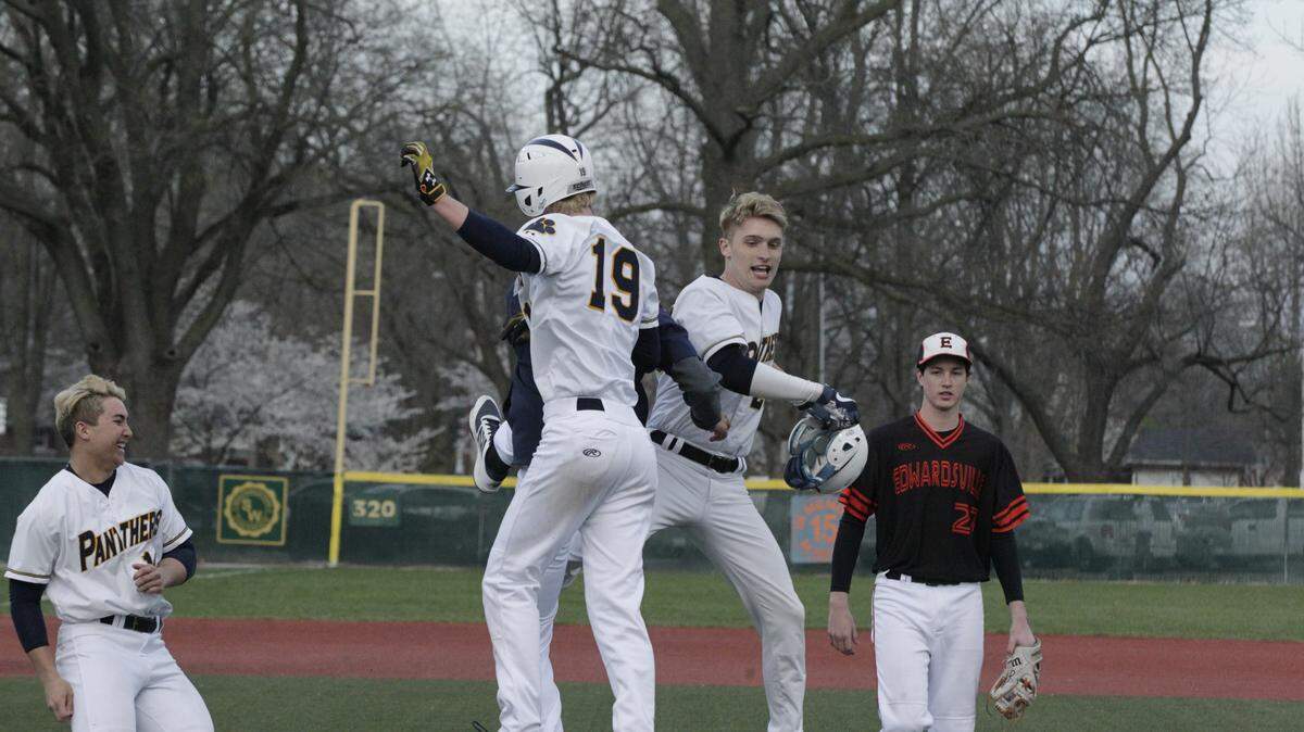 O'Fallon's Nick Boone and Quinn Lowery (19) celebrate an extra-inning win over Edwardsville on Tuesday. Boone got the game-winning hit, a single in the bottom of the eighth, that plated Lowery and earned the Panthers a Southwestern Conference victory.