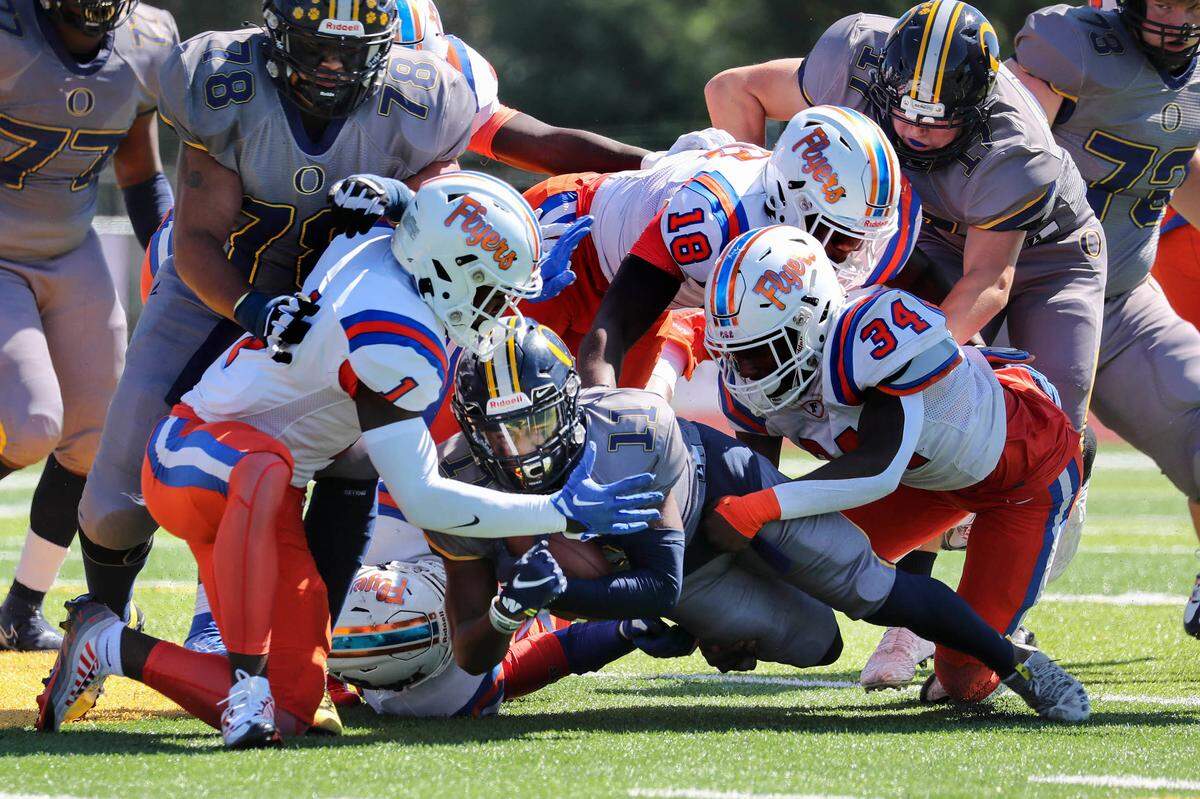 O’Fallon’s Christopher Caldwell carries the ball for some tough yardage during Saturday’s Southwestern Conference game against East St. Louis. The Panthers ultimately dropped a 60-21 decision.