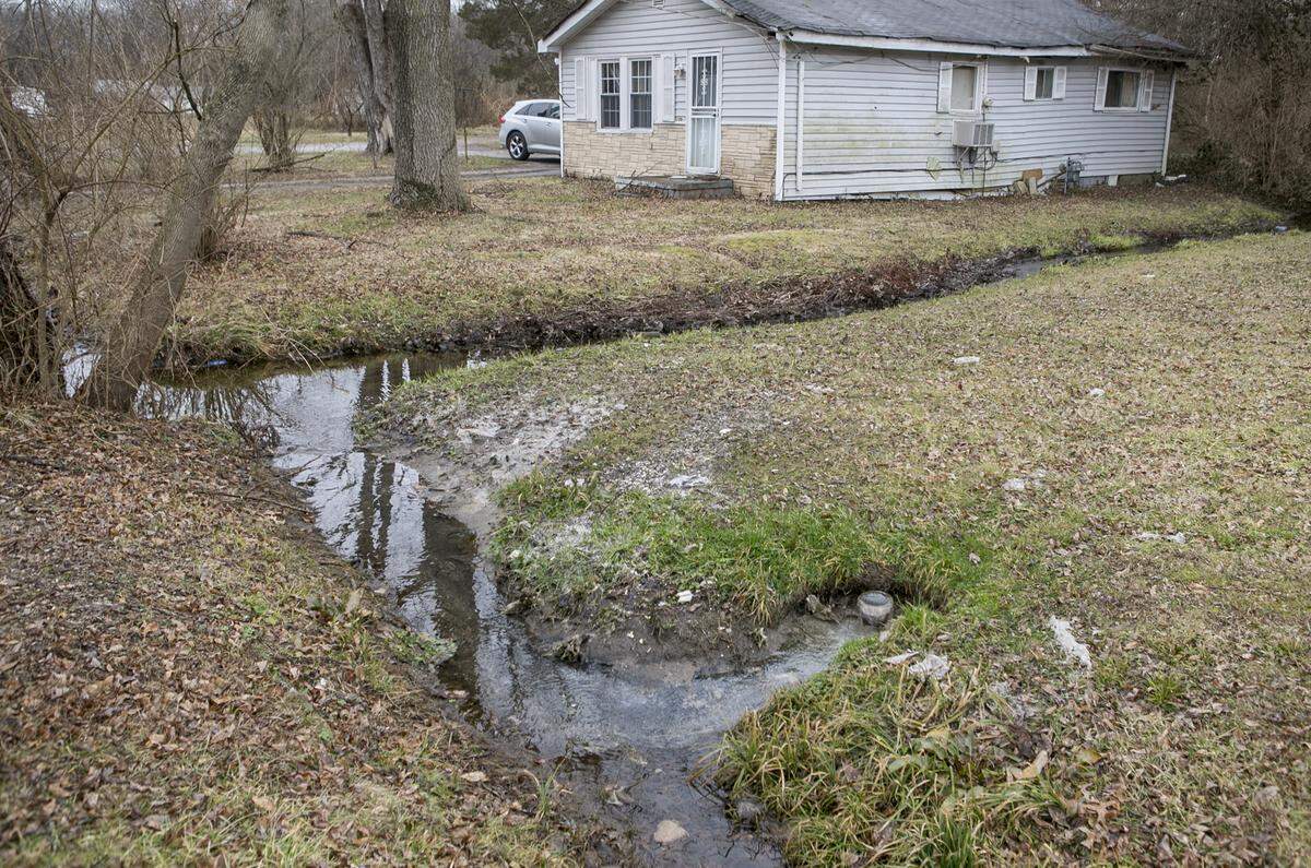 What appears to be raw sewage and storm water are being pumped out of a pipe in the 200 block of North 82nd Street in Centreville. Neighbors complain about the stench when the temperatures are warm. Tampons, toilet paper and other items can be seen in the water and on the ground near the pipe.