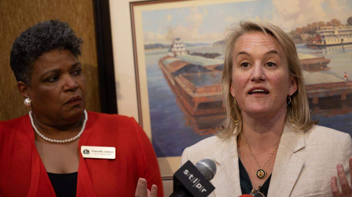 U.S. Rep. Nikki Budzinski speaks next to Cahokia Heights Chief of Staff Francella Jackson during a Granite City press conference about recent federal spending cuts and how they affect local communities.
