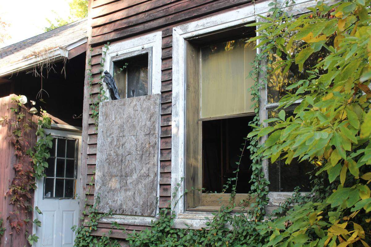 Broken and boarded-up windows are among signs of neglect on a historic home at 107 E. D St. near downtown Belleville.
