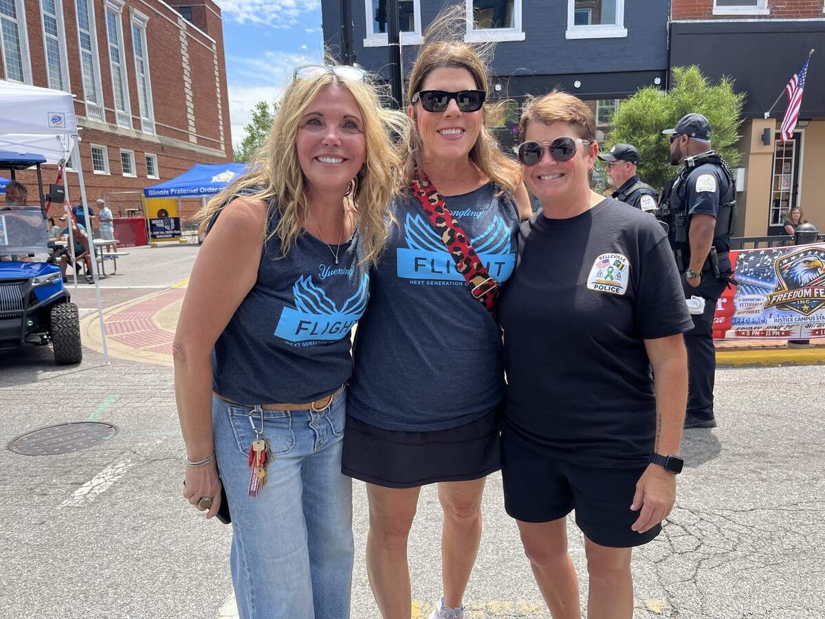 Renae Eichholz, co-owner of Copper Fire restaurant and bar and organizer of the Rock the Blue festival, poses for a photo with her friend, Michelle Young, and Belleville Mayor Jenny Gain Meyer on Saturday.