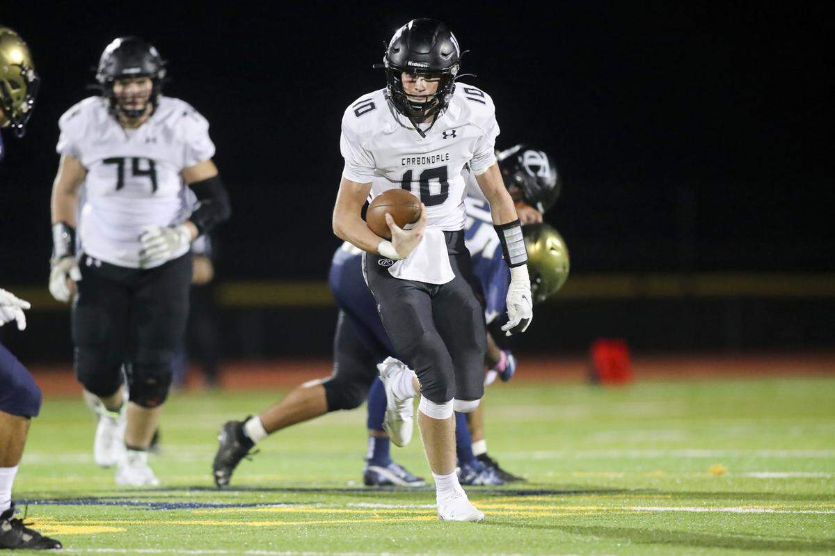Carbondale’s Brock Bowlby carries the ball during Friday night’s South Seven Conference matchup with Althoff. The Terriers ultimately prevailed 10-7.