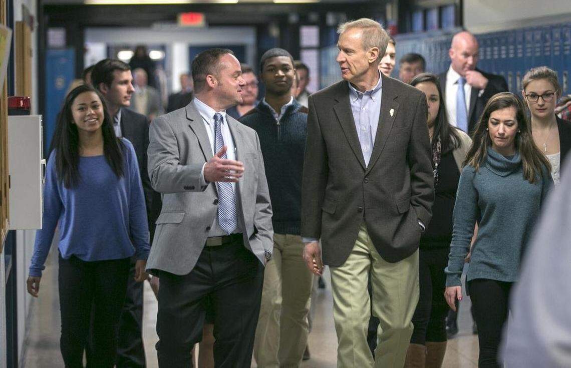 Former Belleville East High School principal Jason Karstens speaks with Illinois Gov. Bruce Rauner during a 2016 tour of the campus.