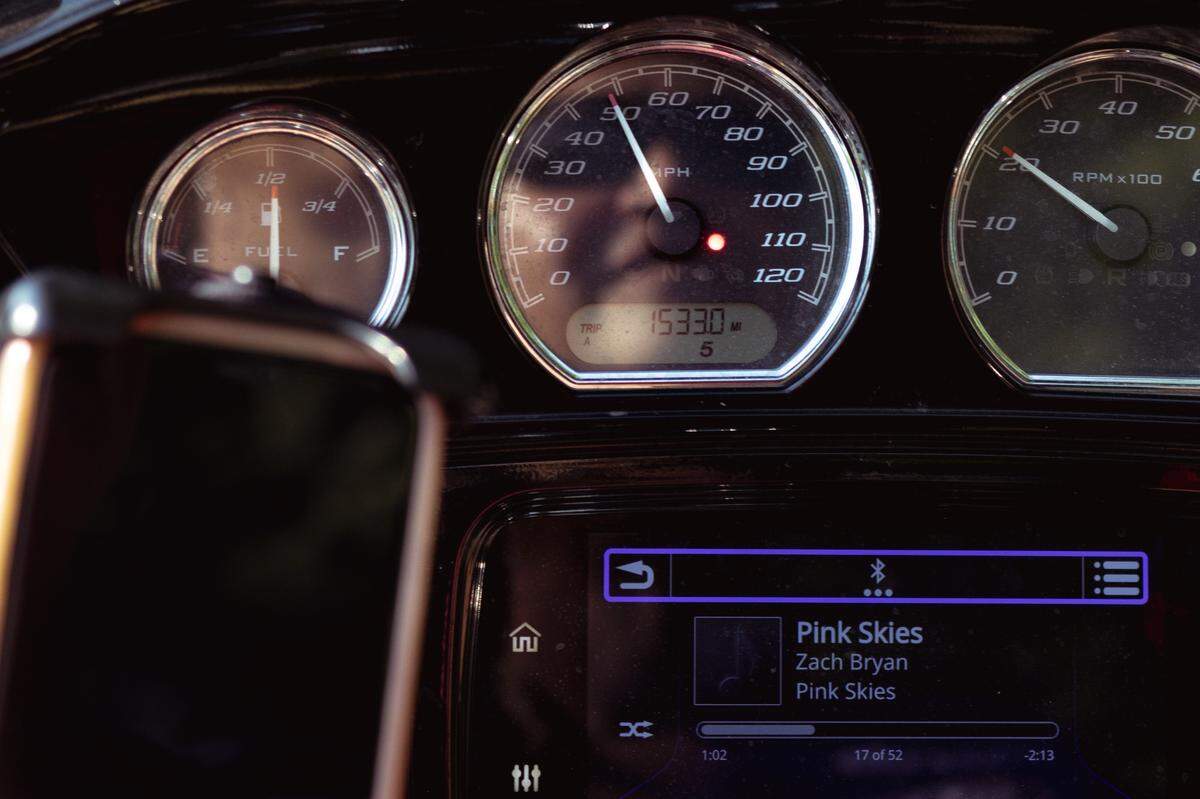 Tina Weber is reflected in her motorcycle’s speedometer as she listens to Zach Bryan during a morning ride on Sunday, July 14, 2024, in Collinsville, Illinois.