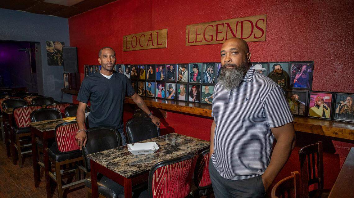 Local Legends Listening Room and Cigar Bar in East St. Louis owners Corey Allen and Shawn Taylor stand by the local legends wall of fame. The small venue focuses on letting local talent to perform live, be creative and free to express themselves without restrictions.