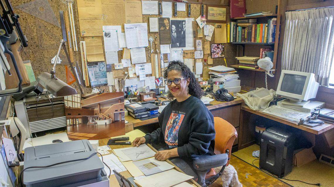 Elise Preston Mallory sits in the office of her late father, Janfrey Preston. Elise is working on a project to display the collections of her father. Janfrey Preston was an artist and construction manager that worked on many significant projects in the city of East St. Louis.