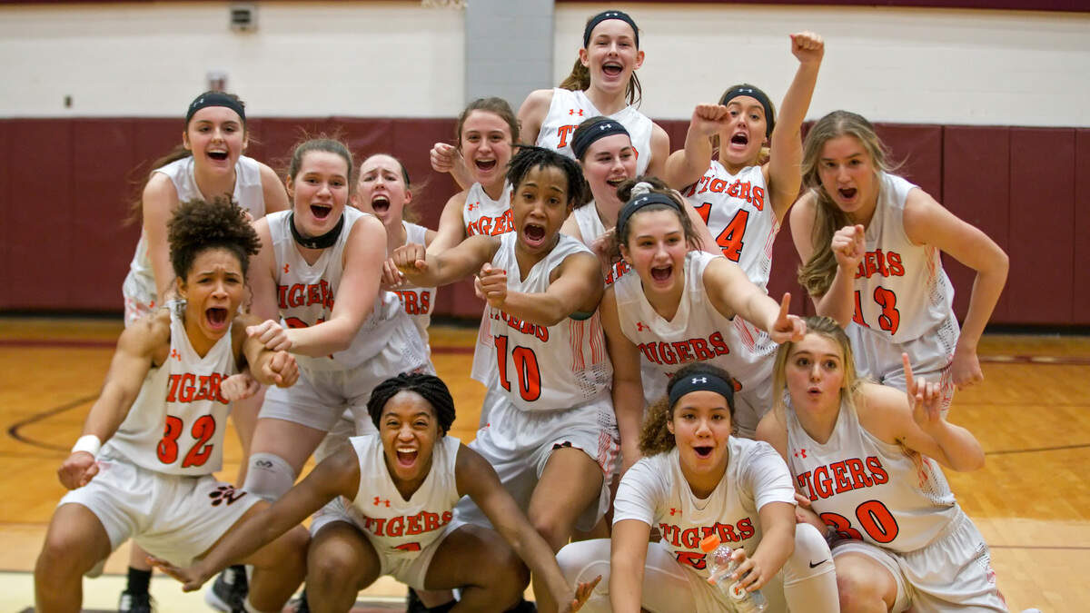 The Edwardsville Tigers celebrate their 64-44 victory over Belleville East Lancers during the Class 4A Quincy Regional girls basketball Championship Game played at Belleville West High School on Thursday.