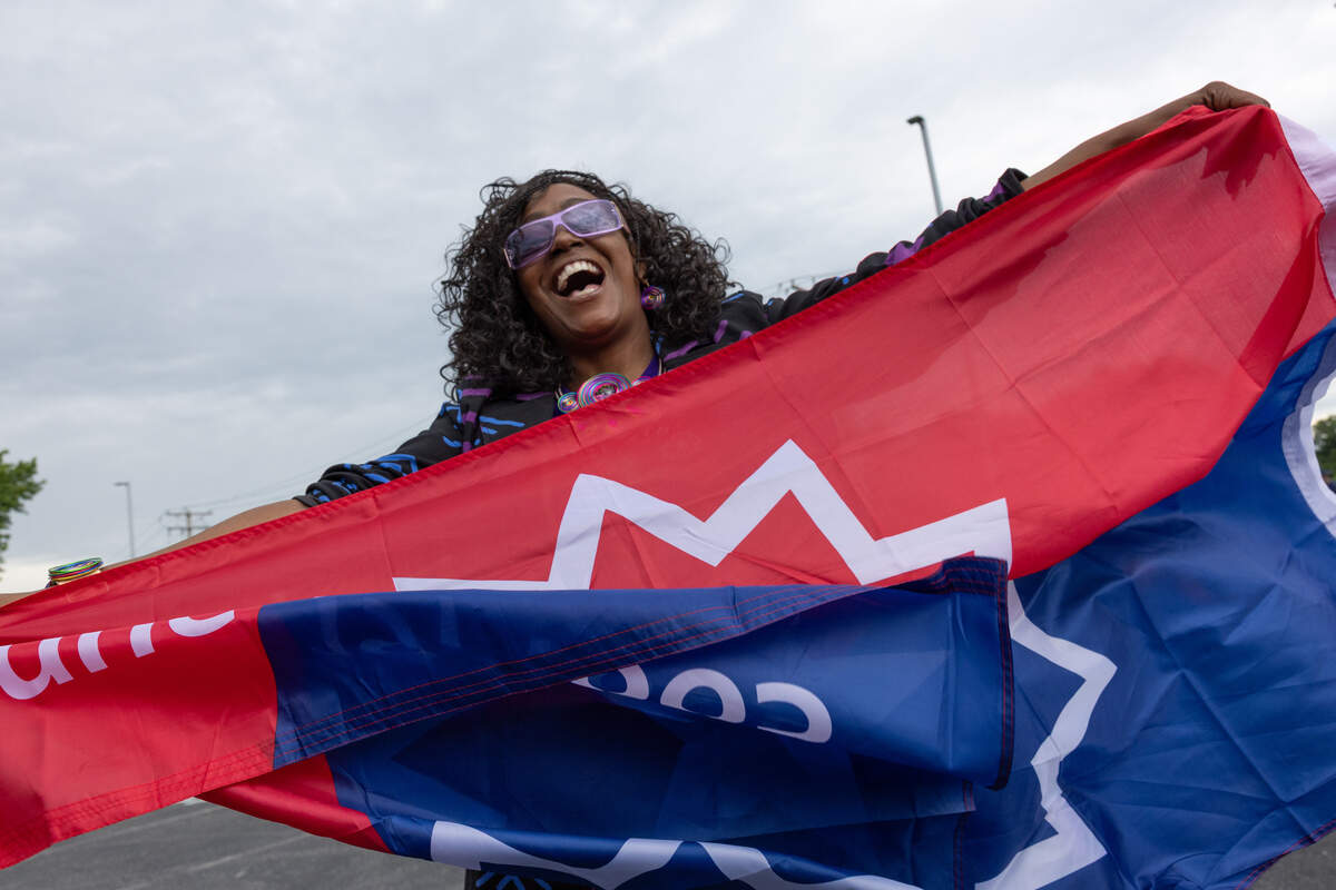 Stephanie Bush, president of Community Development Sustainable Solutions, holds a Juneteenth flag prior to the start of a parade in East St. Louis on June 18.