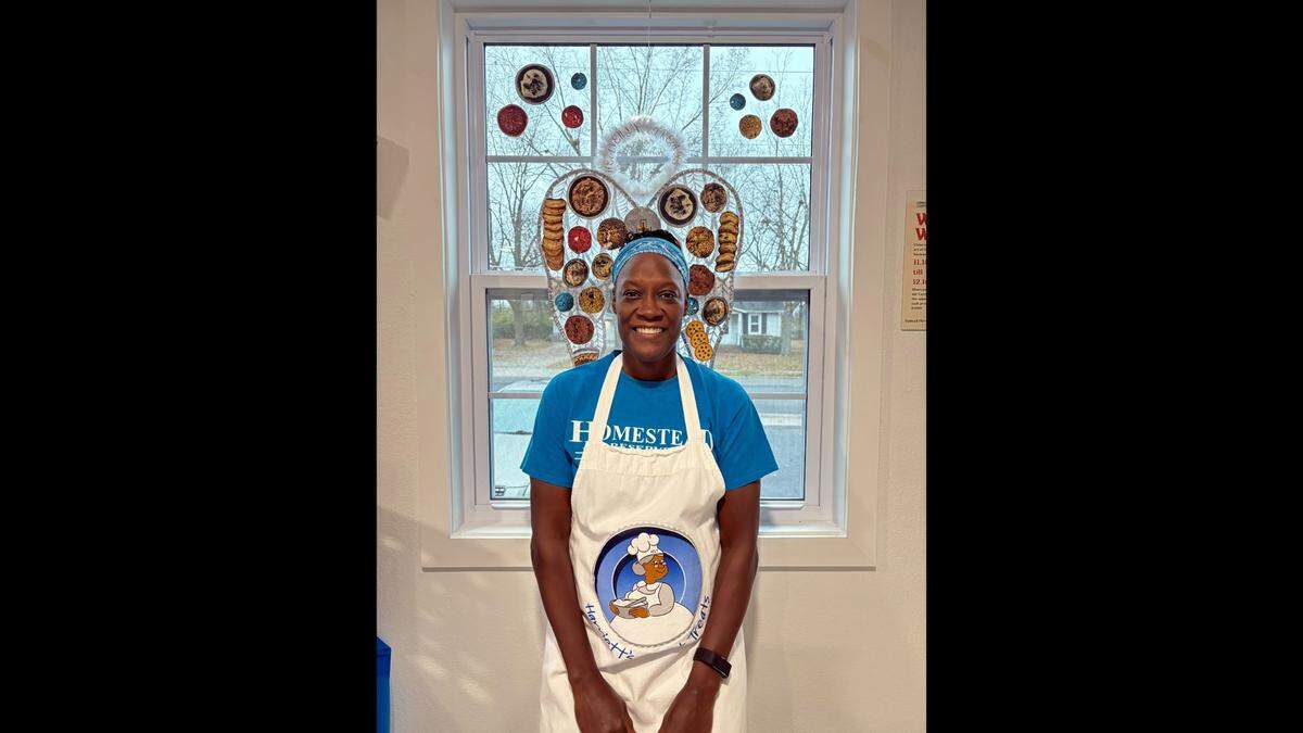 Owner Lachelle Stevenson stands at the cookie wings at Harriett’s Sweet Treats.