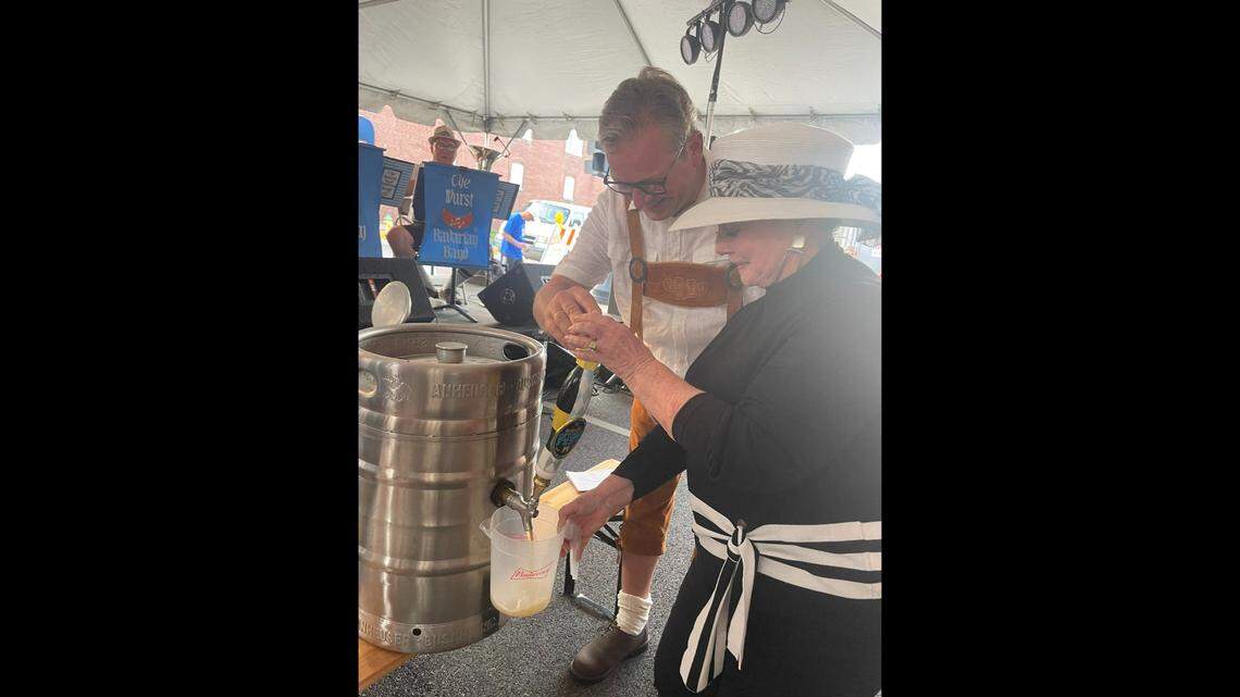 Belleville Mayor Patty Gregory taps the Golden Keg on Friday to kick off Belleville Oktoberfest with help from Michael Dreier, mayor of Paderborn, Germany, Belleville’s sister city.