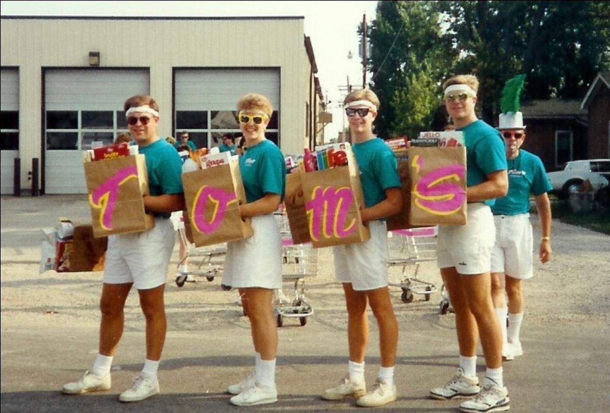 Four children of Tom’s Supermarket founders Tom and Betty Ann Norrenberns have some fun advertising the business. Left to right are Don, Bonnie, T.J. and John Norrenberns.