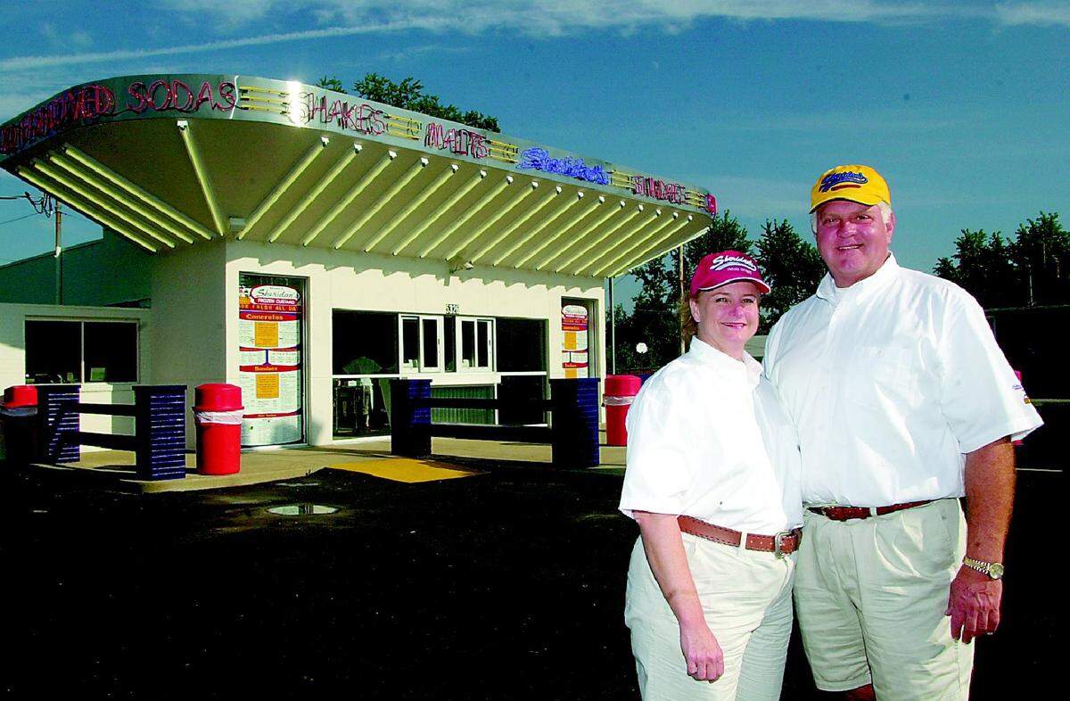 Sheridan's Frozen Custard owners Jim and Becky Biermann stand in front of their newly opened shop in this BND file photo from September 2003.