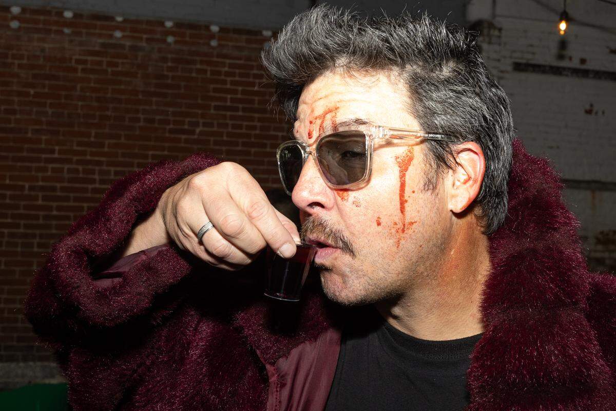 A party-goer in costume takes a shot at midnight at Spaces, where management gave everyone in attendance a free drink.