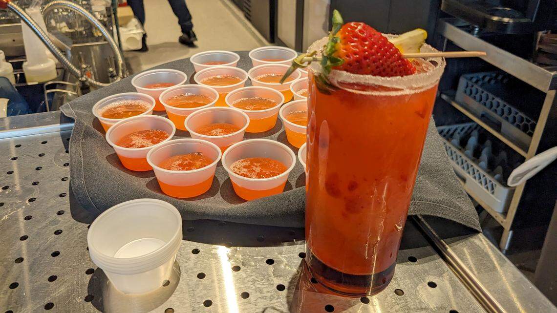 A strawberry frozen margarita and samples of strawberry lemonade