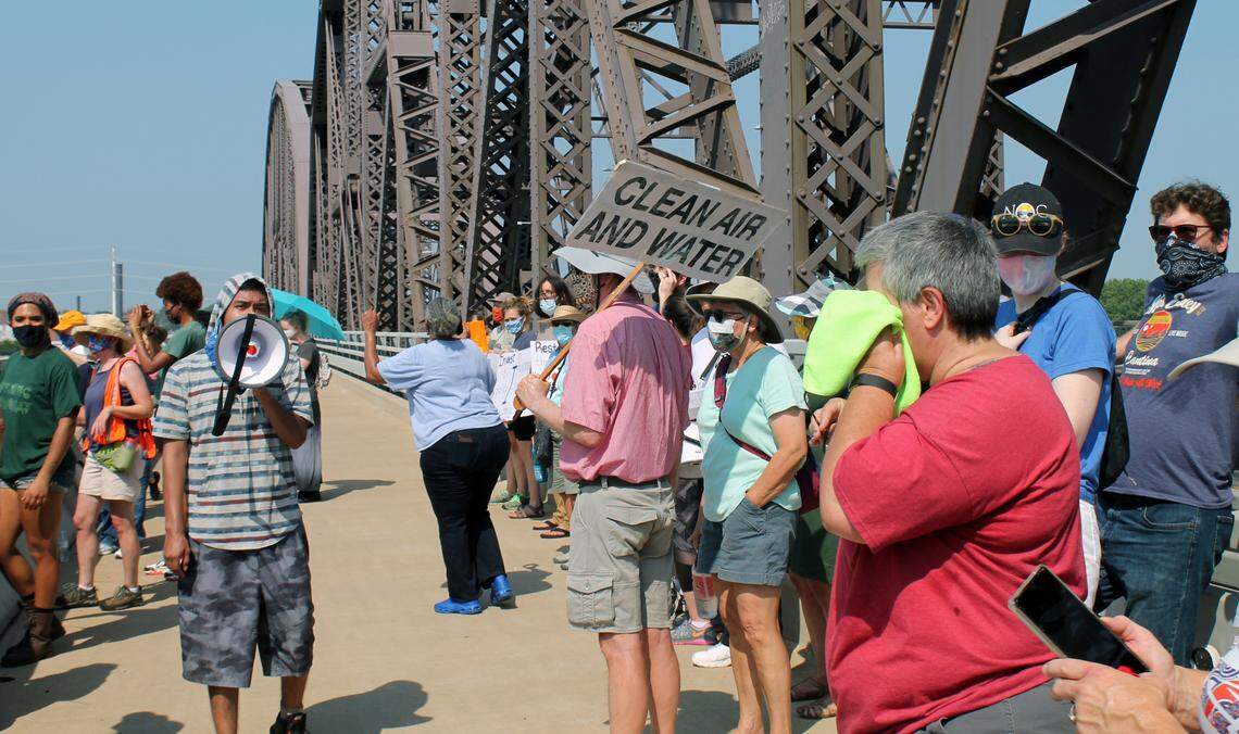 United Congregations of Metro East leader Josue Martinez-Herrera leads marchers in chants on the McKinley Bridge during the Air Quality Rally for Environmental Justice on Saturday, July 24, 2021.
