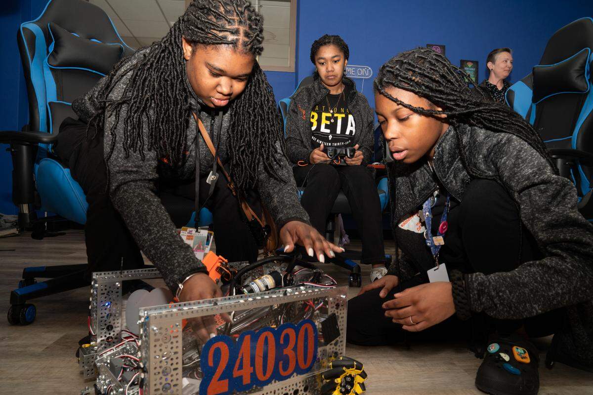 Members of the Skyline Robotics team at East St. Louis Senior High School show off their robot, “Big Bernie,” on April 9, 2024.