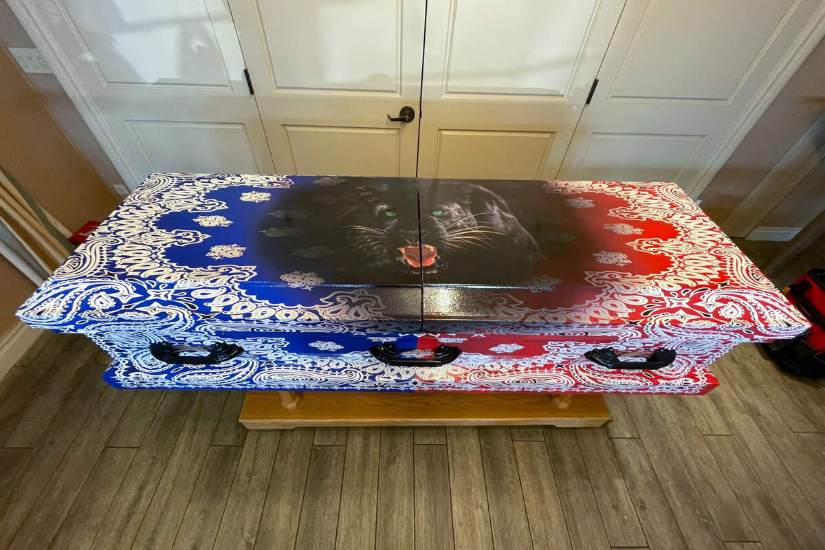 Victoria Lanier of Los Angeles Casket Wraps designed a casket for Jermaine Carter, who had been a member of the Bloods and went by “O.Y.G. Redrum 781.” Carter requested this unique design six weeks before he died of cancer at 49.