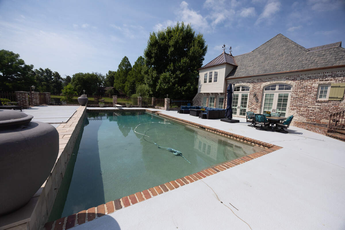 An in-ground pool has its own dedicated pool facility, complete with lockers and shower.