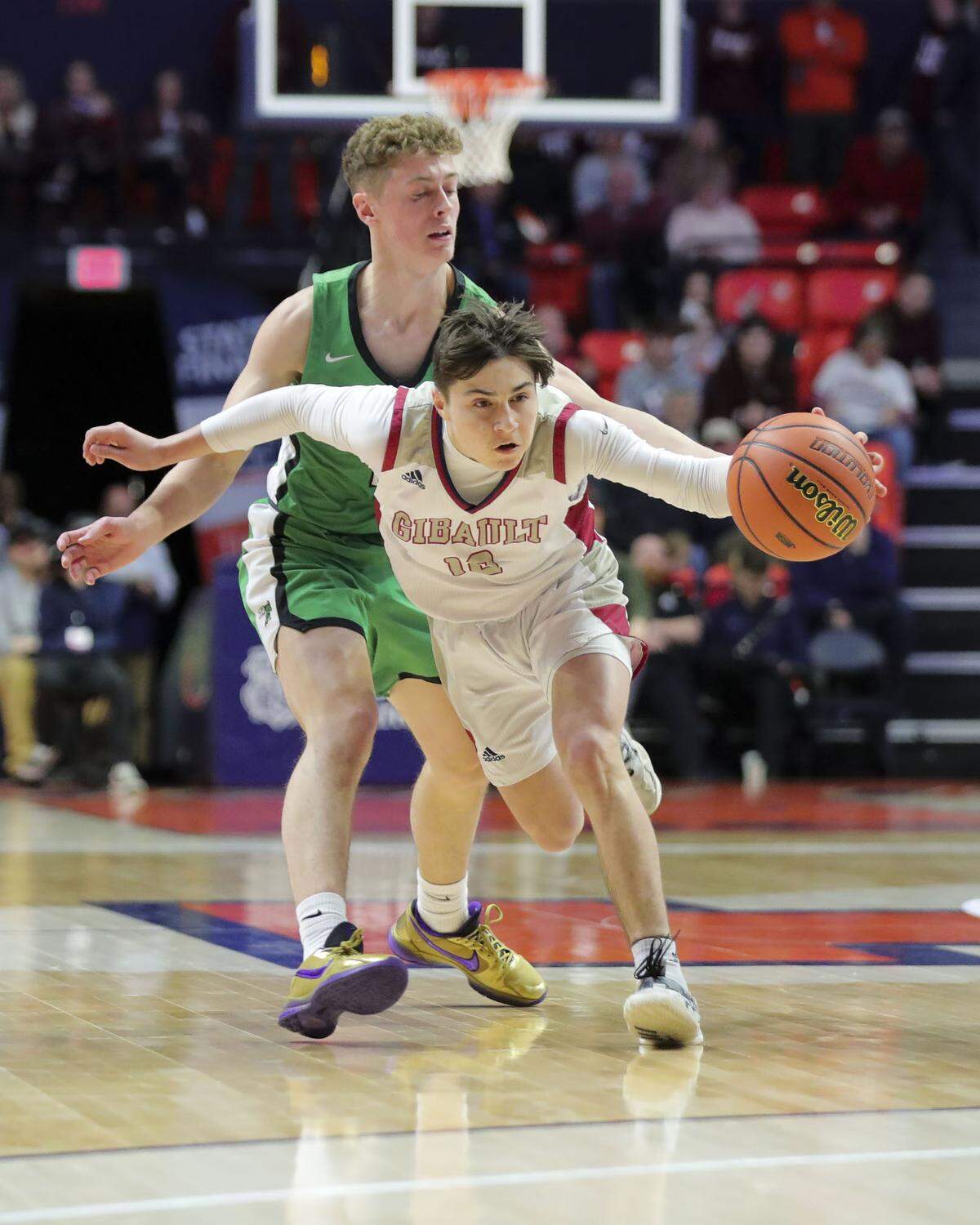 Gibault’s Kanen Augustine brings the ball up court during Saturday’s IHSA Class 1A state championship game against Scales Mounds at the State Farm Center on the campus of the University of Illinois. Gibault ultimately prevailed 65-45 to claim the state title.