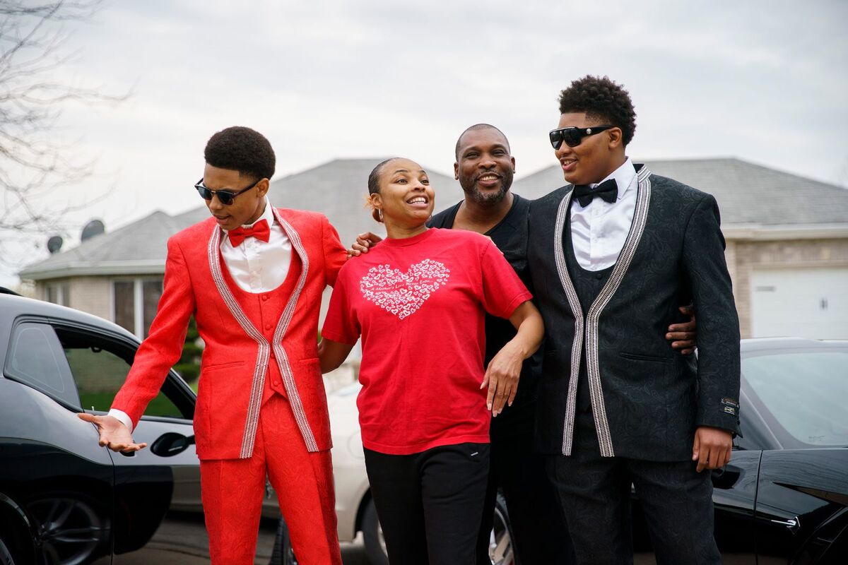 Elizabeth and Rodney Posley, center, pose for a family photo with sons Jeremiah, left, and Josiah outside their Sauk Village home before the brothers leave for their school’s prom.