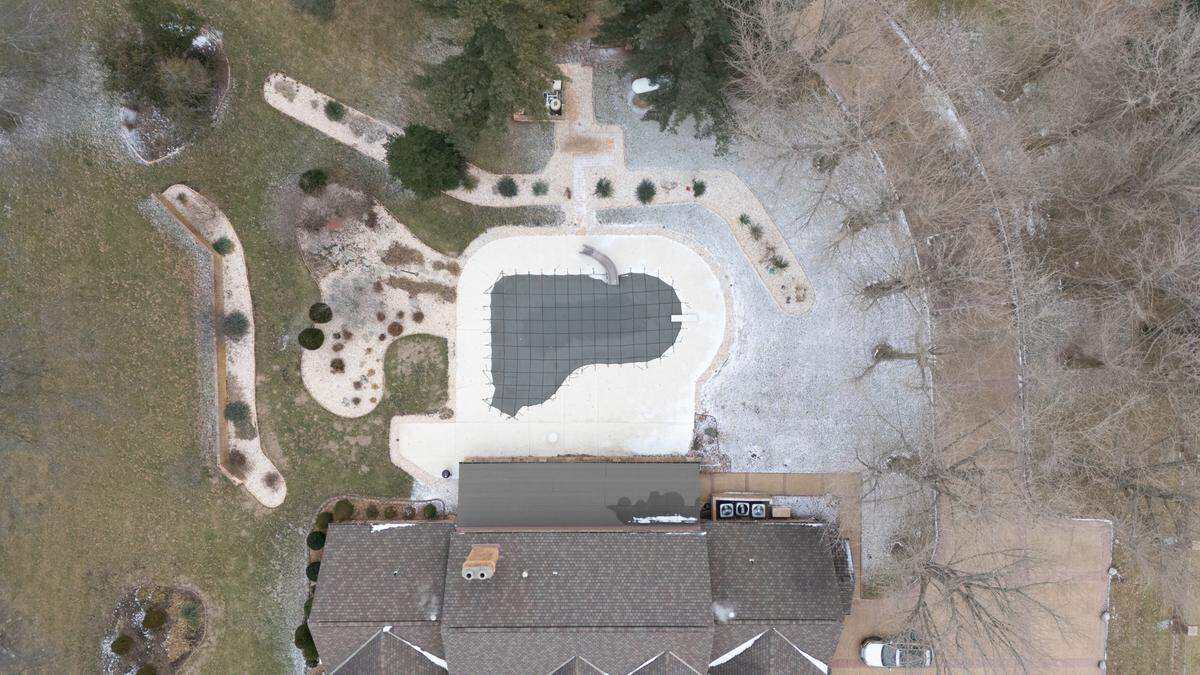 The backyard consists of an in-ground pool and patio perfect for summer hosting parties.