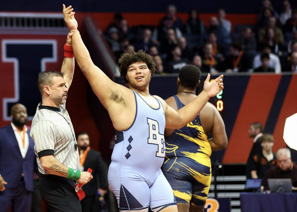 Belleville East’s Jonathan Rulo has is hand raised after defeating Round Lake’s William Cole in the Class 3A 285-pound championship match at the IHSA Individual Wrestling State Finals on Saturday.