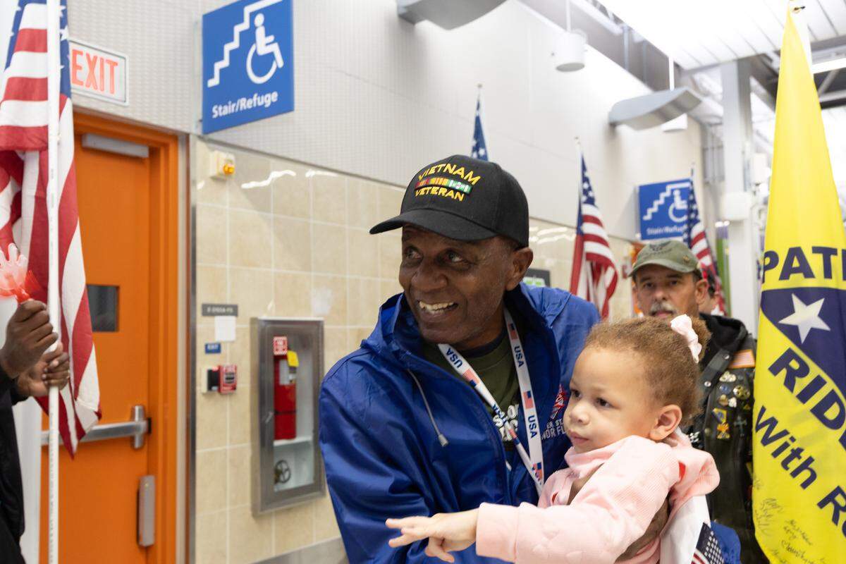 Vietnam War veteran Joe Jefferson picks up his granddaughter after returning from Greater St. Louis Honor Flight.