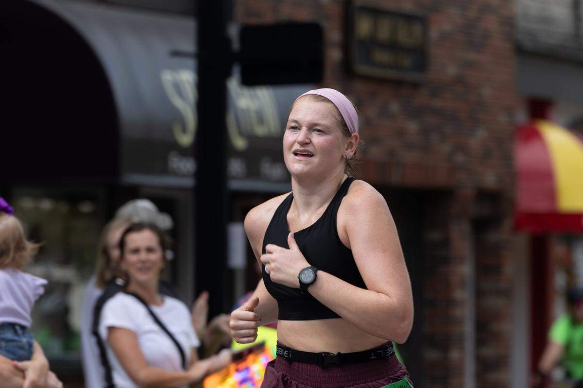 Belleville native and overall female race winner Megan Siebel smiles as she crosses the finish line at the Belleville Marathon on Sept. 28, 2024. “Everyone has been so great, the volunteers were so helpful,” Siebel said.