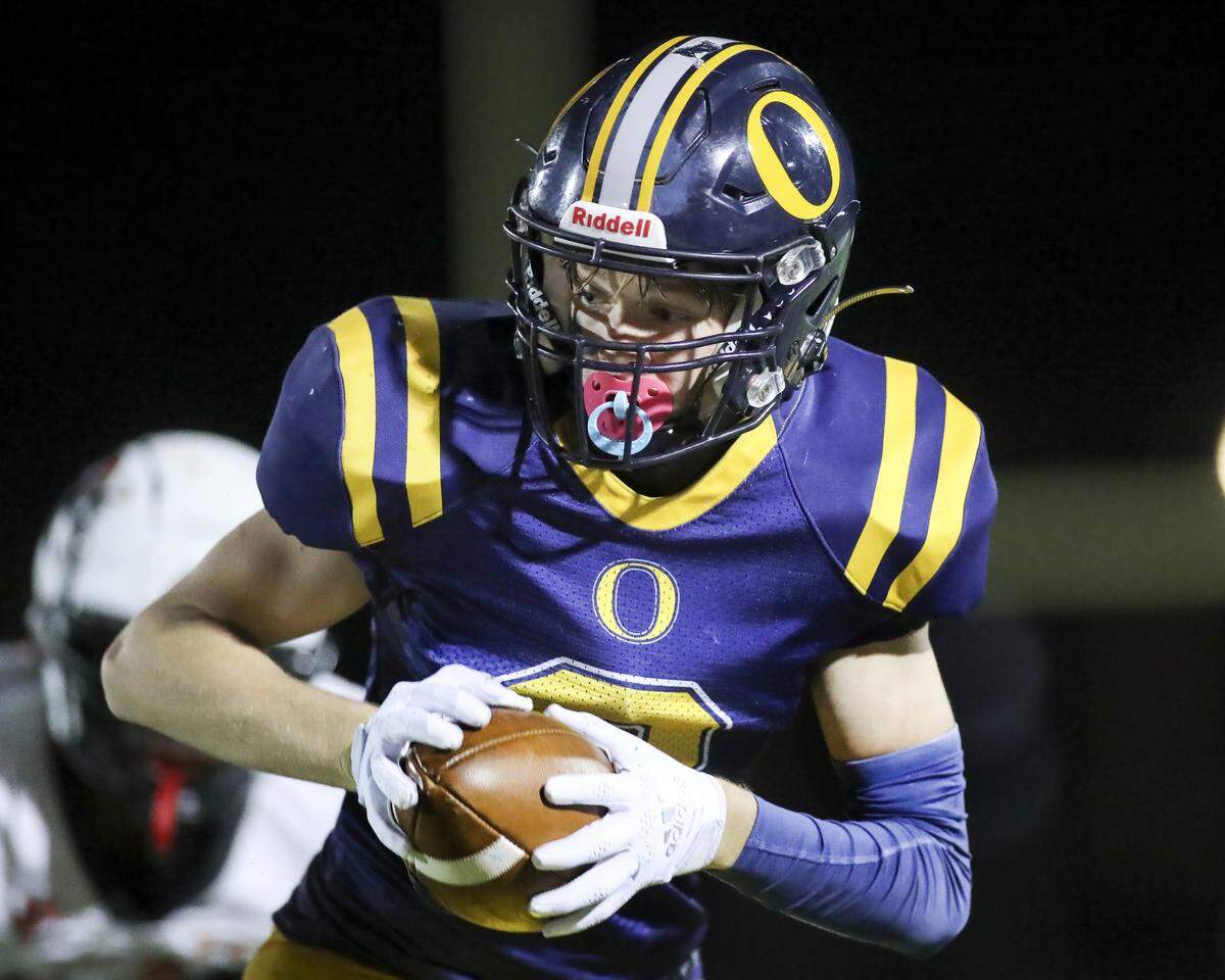 O’Fallon’s Camryn Sheehan heads upfield after hauling in a pass during Saturday night’s IHSA Class 8A playoff game against Edwardsville. The Panthers lost 43-36.