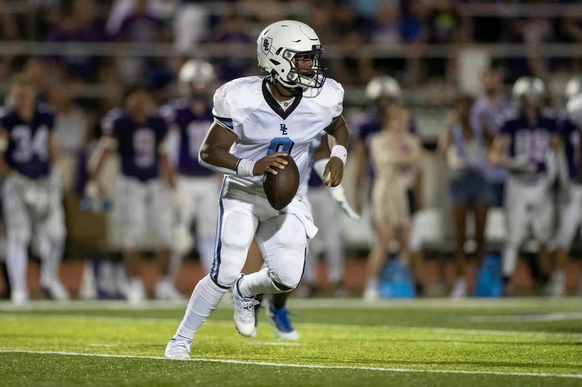Belleville East’s Darron Millender Jr. looks downfield for an open receiver during a 20-12 win against Collinsville in the 2022 season opener. Minnelder Jr. and the Lancers improved to 2-1 following a 52-19 road victory against Metea Valley on Friday night.