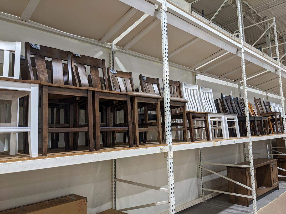 Amish dining chairs line the back shelves at Mueller Furniture and Mattress Warehouse Showroom in Fairview Heights.