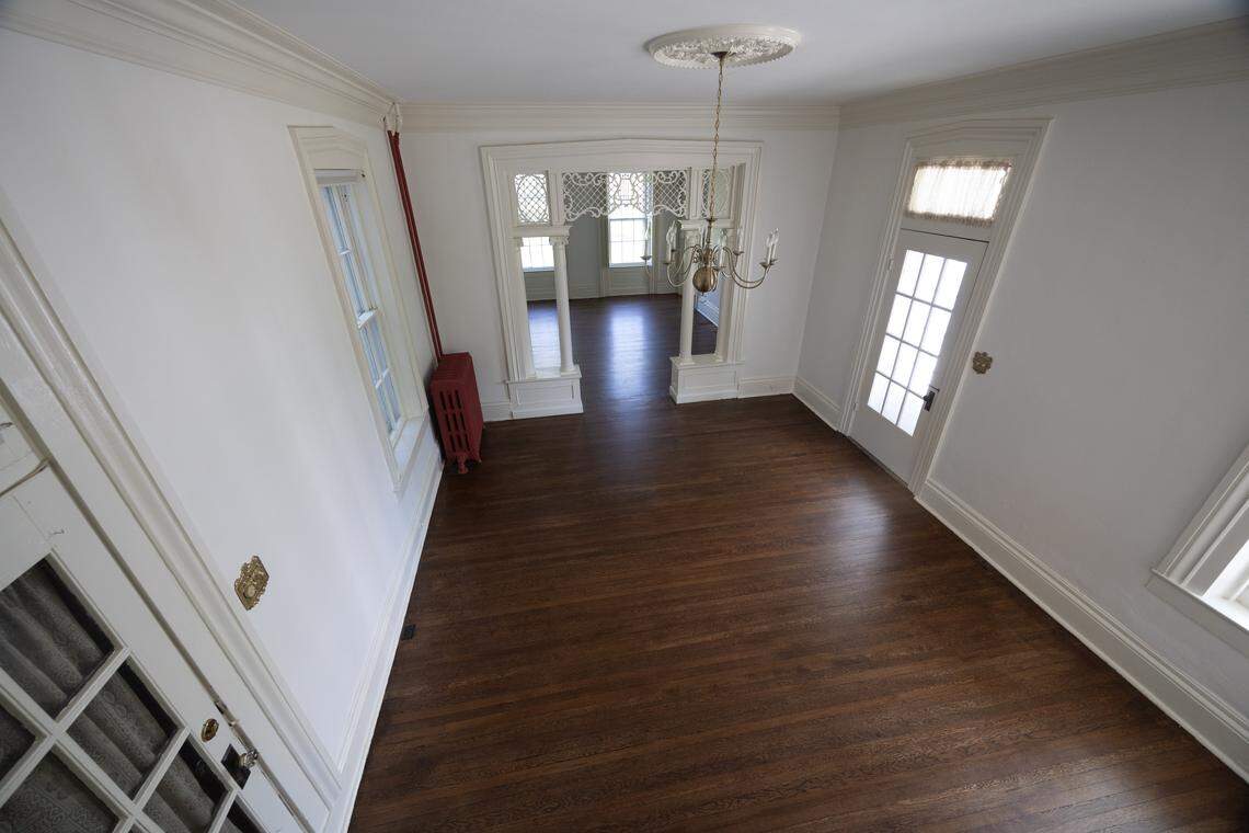 The dining room of the home has a charming chandelier, radiator and plenty of natural light.
