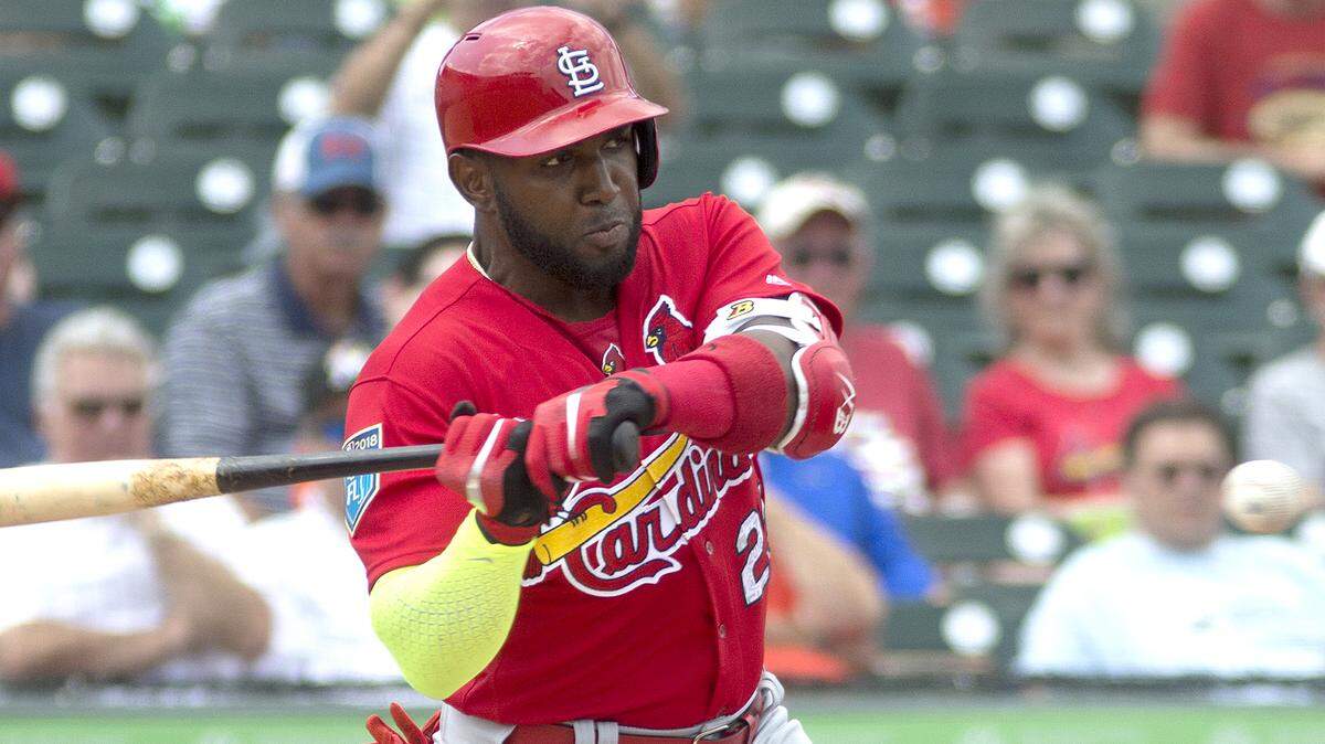 Marcell Ozuna takes a swing during a spring training game in Jupiter, Florida.