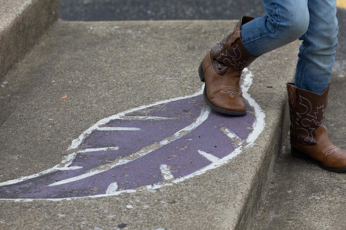 A young protestor against the ban of Native American mascots leaves Kahok stadium at Collinsville High School.