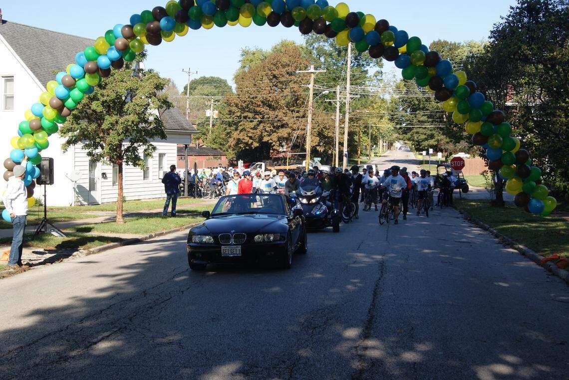 The first group of riders in the Tour de Belleville on Saturday wait to take off at the starting point behind a lead car with Mayor Patty Gregory in the passenger seat.