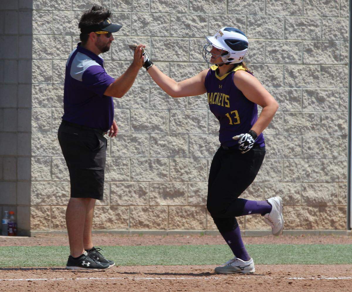 New Athens sophomore accepts a high-five from head softball coach Conrad Widdersheim after slamming a fourth-inning home run at the Johnston City Class 1A Super-Sectional Saturday. New Athens lost to defending state champion Goreville, 4-1.