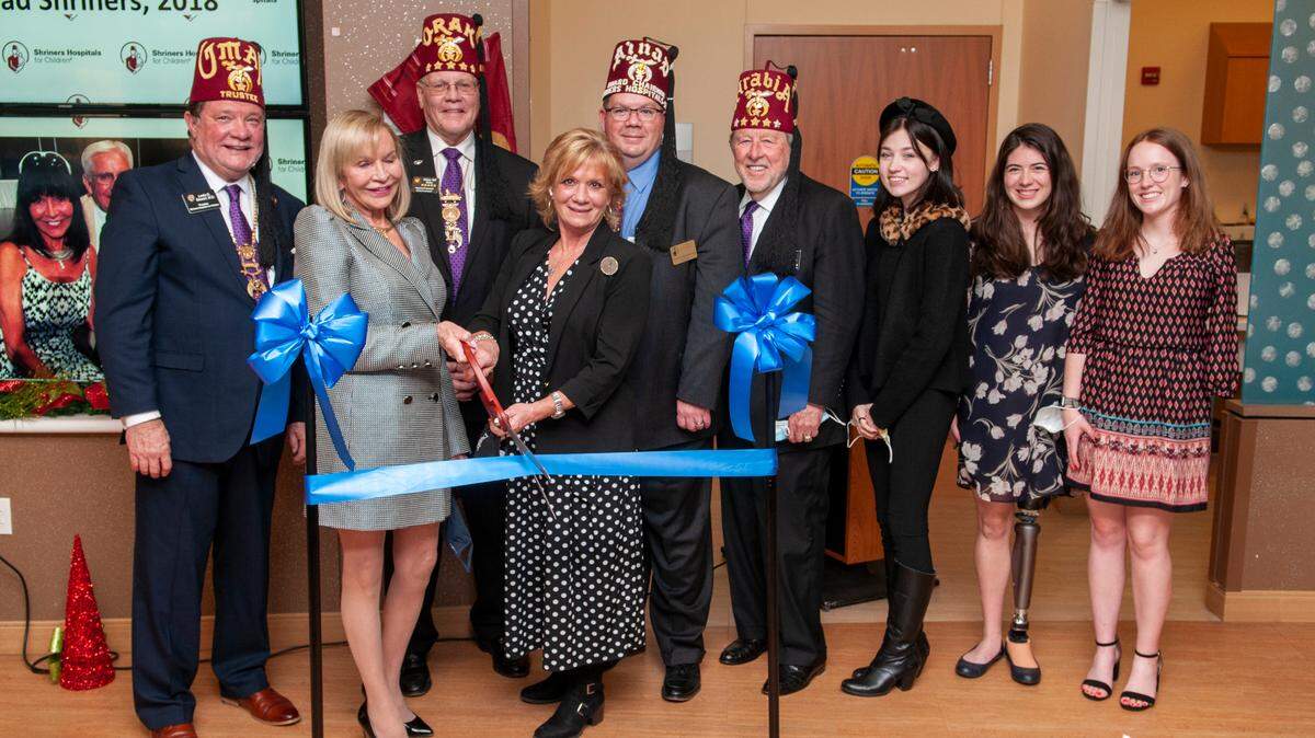 Marcia Billhartz, second from left, participates in the dedication ceremony to name the St. Louis Shriners Hospital for Children lobby in honor of her brother, Edward Allan, a former leader of the Southern Illinois chapter of Shriners International. Billhartz gave the hospital a $2 million donation.