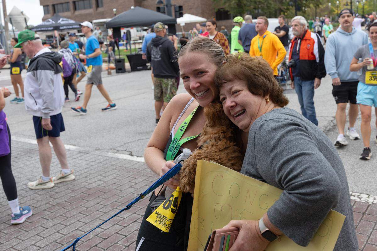Meg Tensing of St. Louis hugs her mother through tears after finishing a half-marathon at the Belleville Marathon on Sept. 28, 2024. “You crushed it,” her mother said through tears as she crossed the finish line. “Absolutely crushed it.” “I never thought I’d do this,” the young Tensing replied.