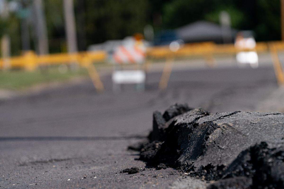 Land subsidence outside of Ruler Foods in Belleville, Ill., where an old mine below the store caused the land surrounding the building to sink into the ground on Sept. 26, 2023.