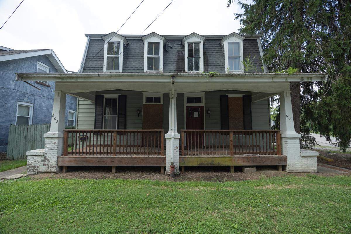 Main Street Redevelopers bought this 1800s frame duplex with a mansard roof for $12,000 and quickly sold it for $240,000 to a woman who got a mortgage loan from Tempo Bank.