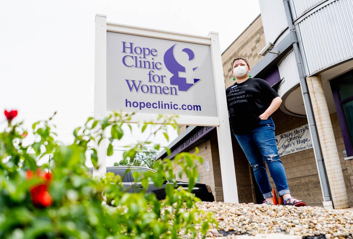Hannah Dismer, a social worker at the Hope Clinic for Women, stands in front of the reproductive health center on May 19 in Granite City. “We have been getting a huge influx of calls, texts and emails from people who had an abortion (several) years ago who are now having feelings come up because the care that they were able to receive is being attacked,” they said. “I think all attacks on bodily autonomy are traumatic in nature.”