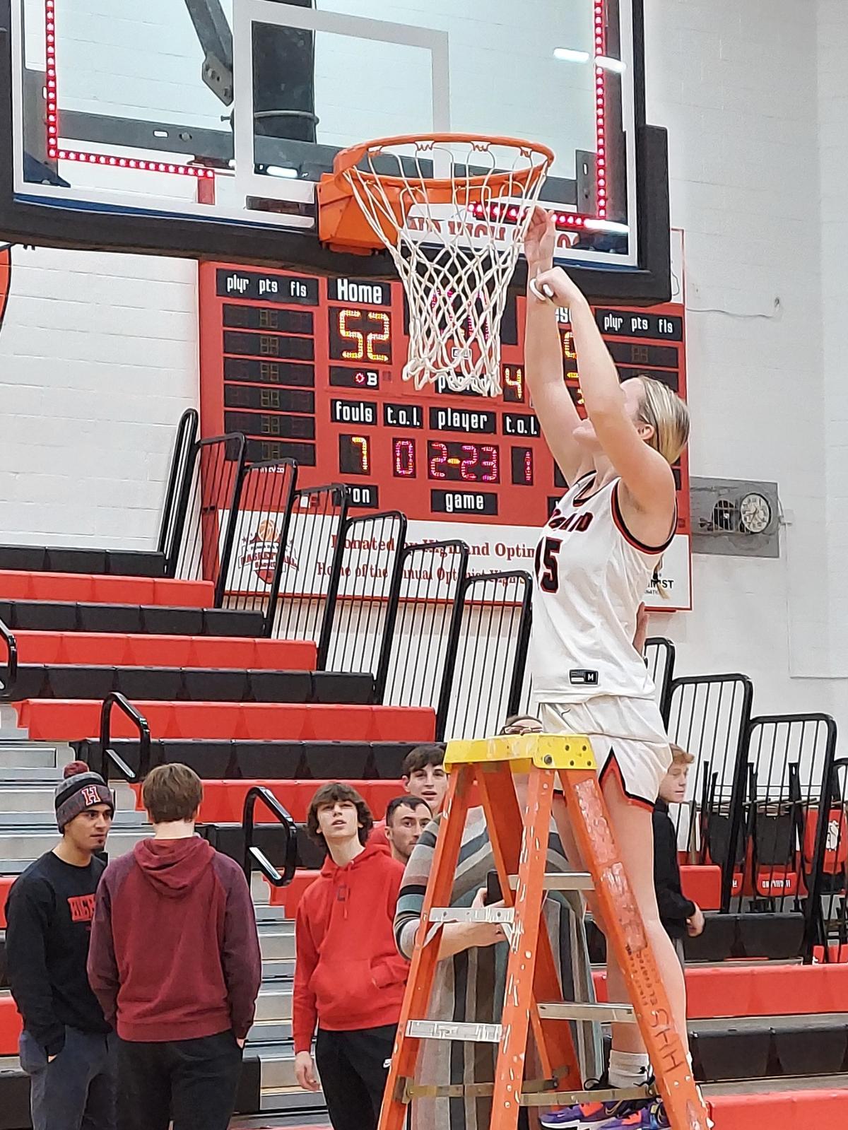 Highland’s Grace Wilke cuts down the net after the teams IHSA Class 3A regional championship win over Waterloo on Feb. 17 at Highland High School. The Lady Bulldogs had more reason to celebrate Thursday night as they defeated Mount Vernon to win the sectional championship.